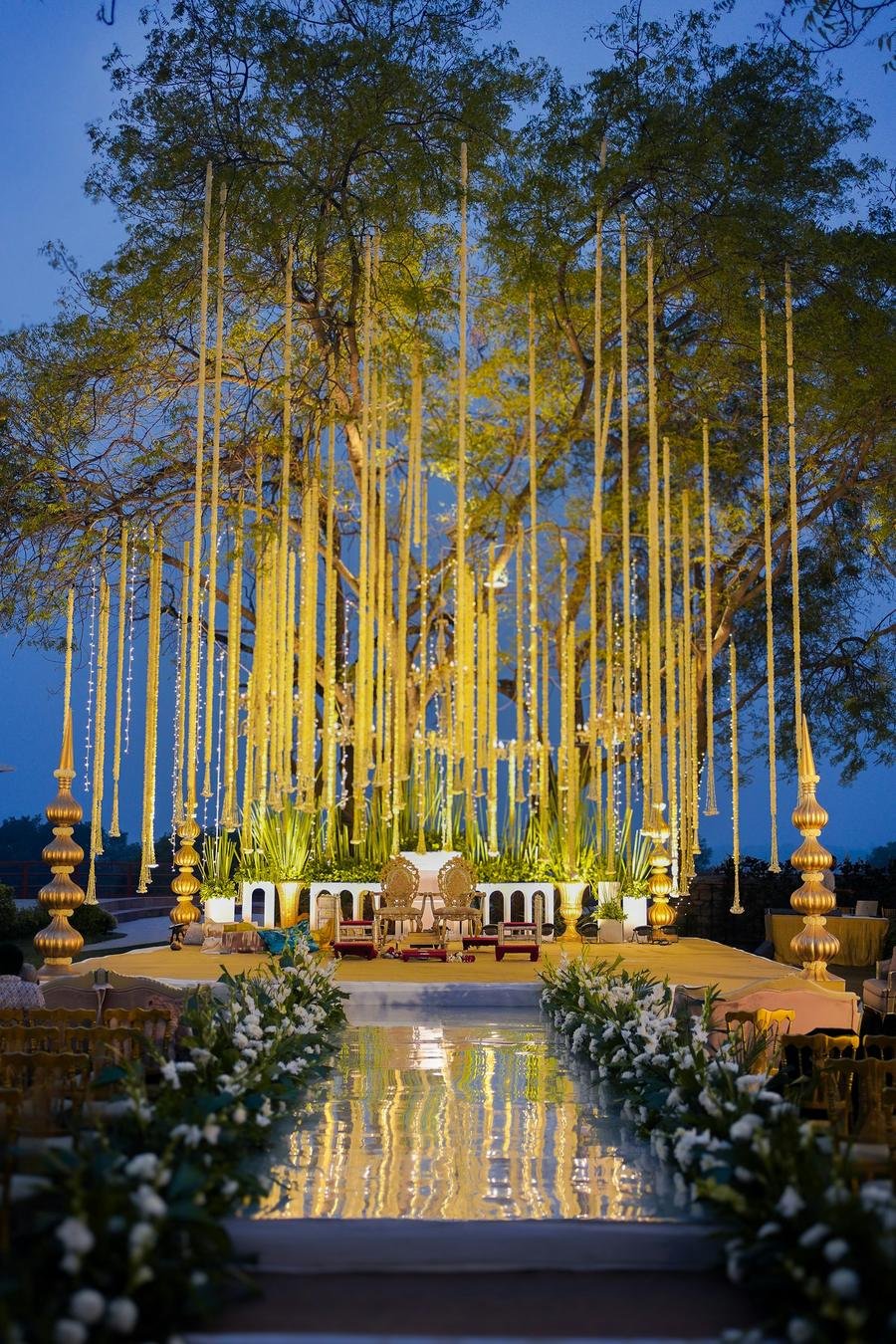 Night wedding aisle under hanging golden lights